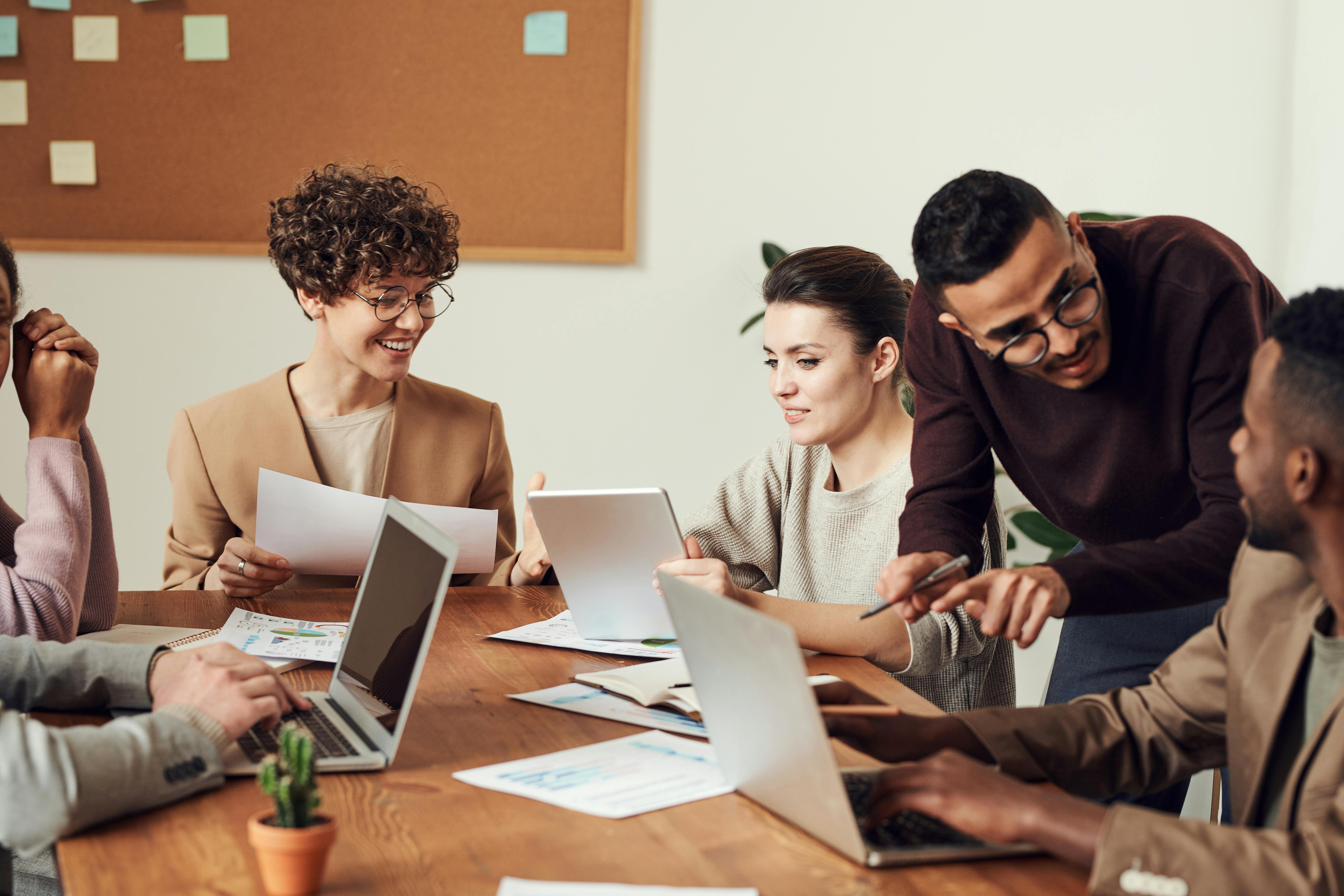 Team collaborating in a modern workspace, showcasing the use of Automated Vacation Rental Management Software for seamless operations.