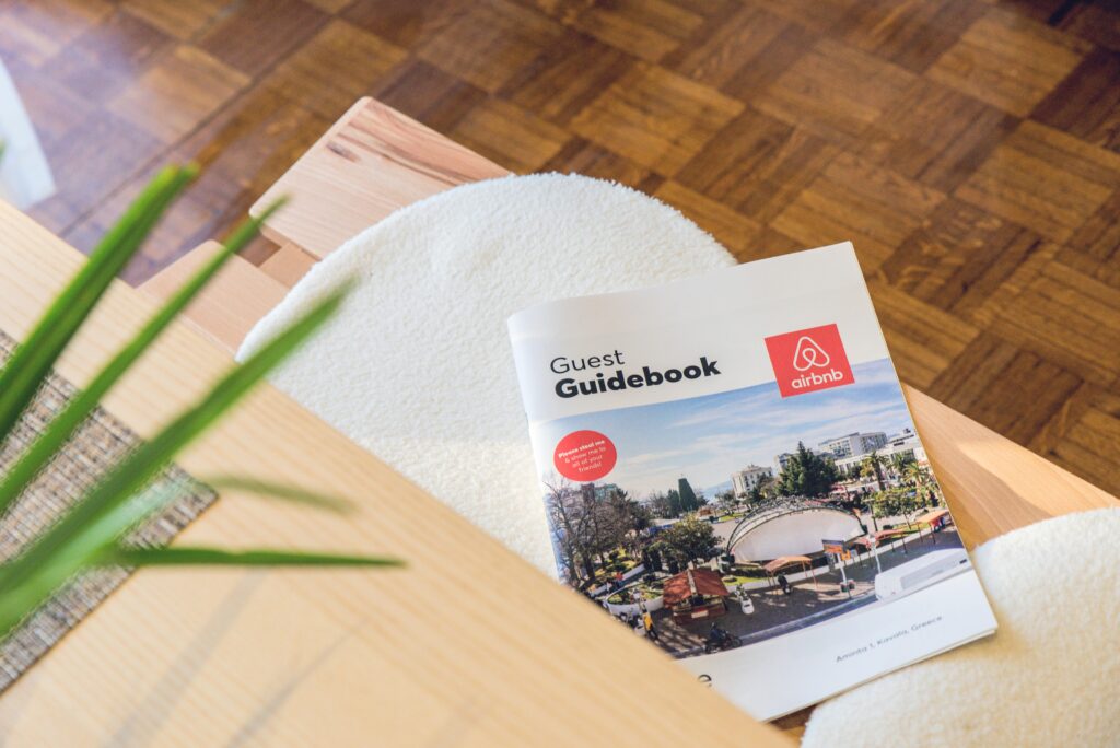 Airbnb guidebook displayed on a coffee table, surrounded by a cozy living room setting.