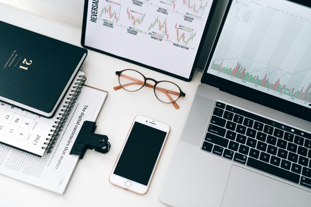 Workstation with charts, graphs, and a laptop, illustrating data-driven insights provided by Automated Vacation Rental Management Software.